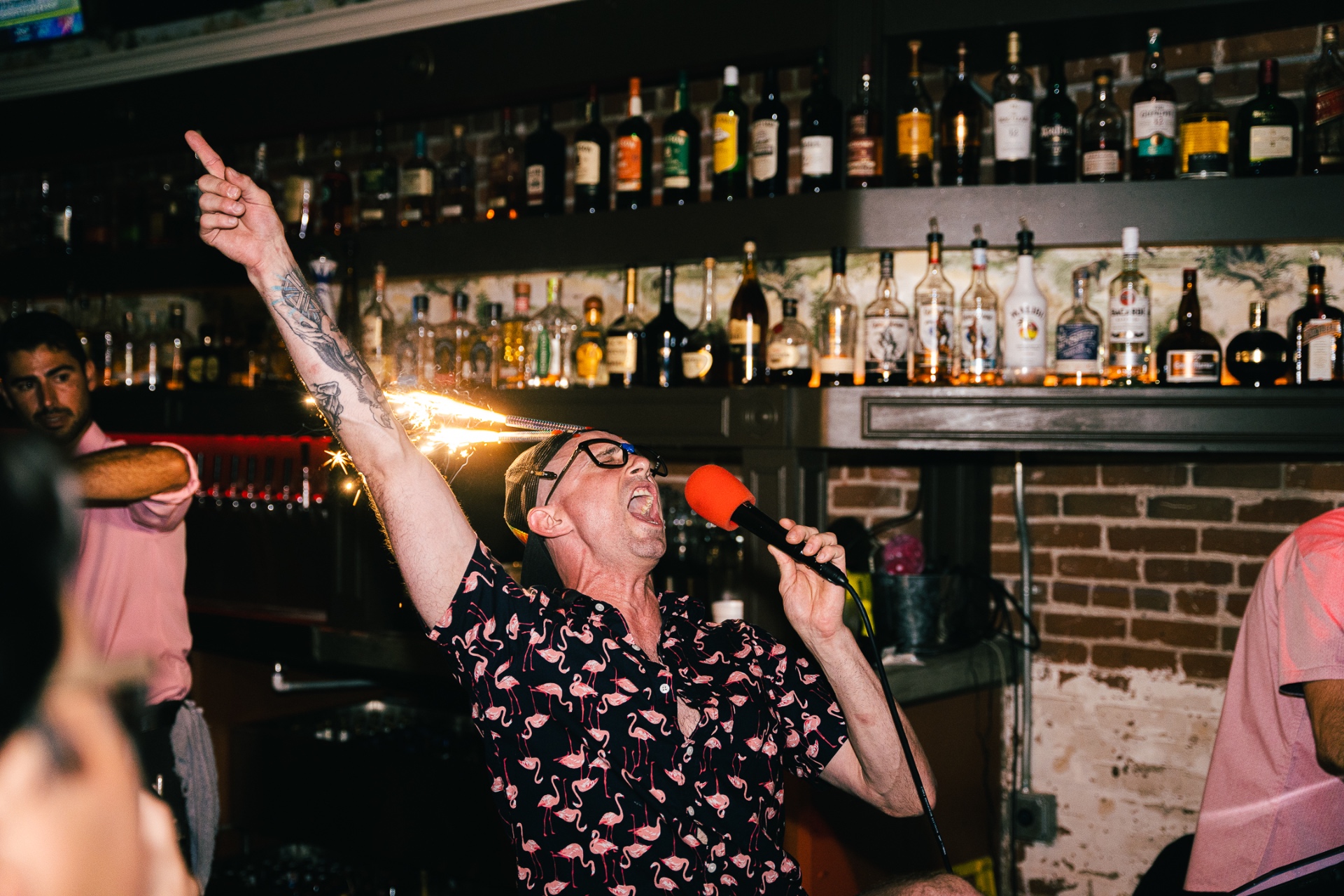 Werewolf Pub regular belting into the mic with sparklers behind the bar